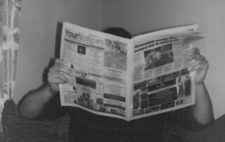 person reading newspaper