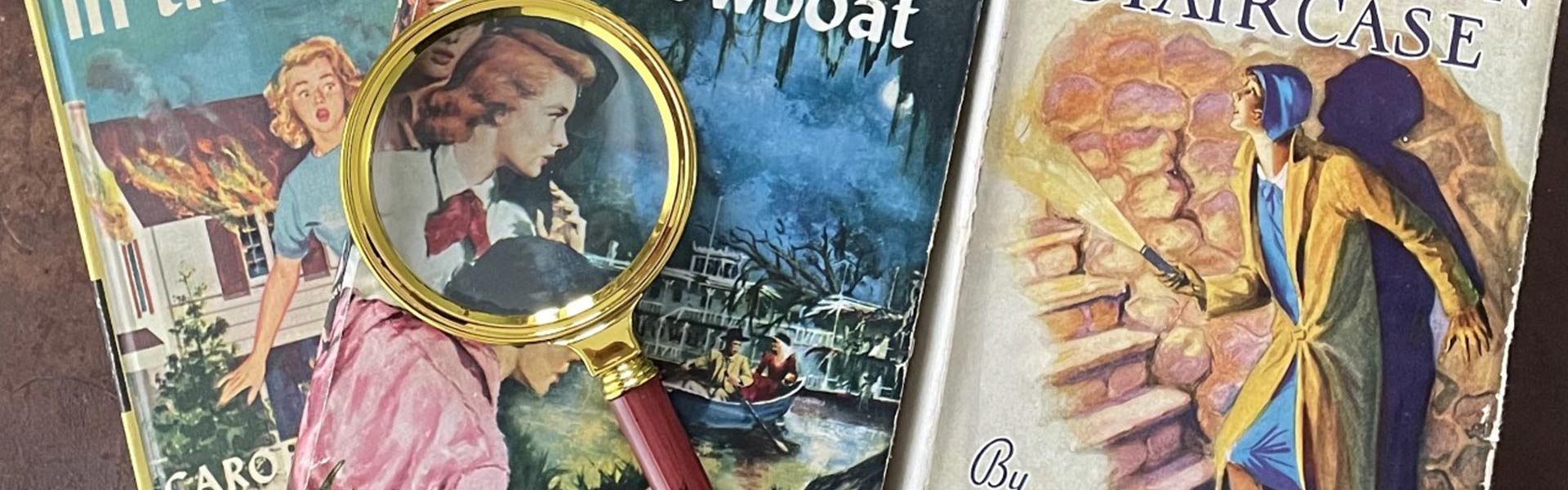 mystery books and magnifying glass