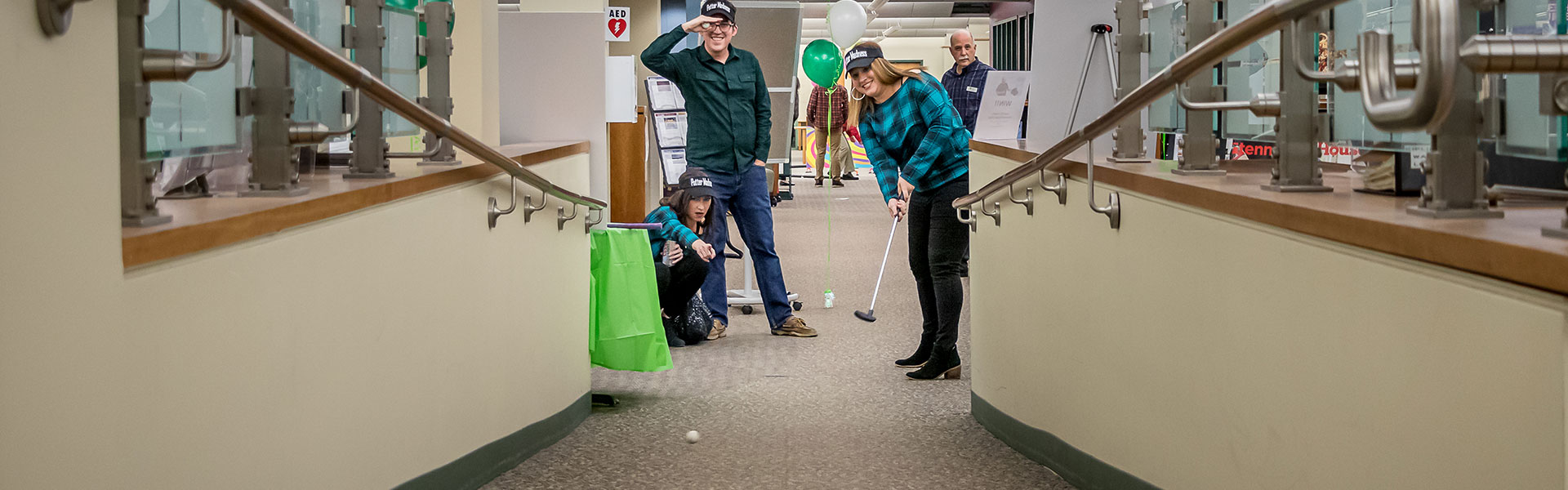 People playing mini golf at Wheaton Public library
